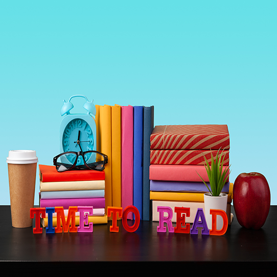 This is a picture of a table with books on it and it says time to read